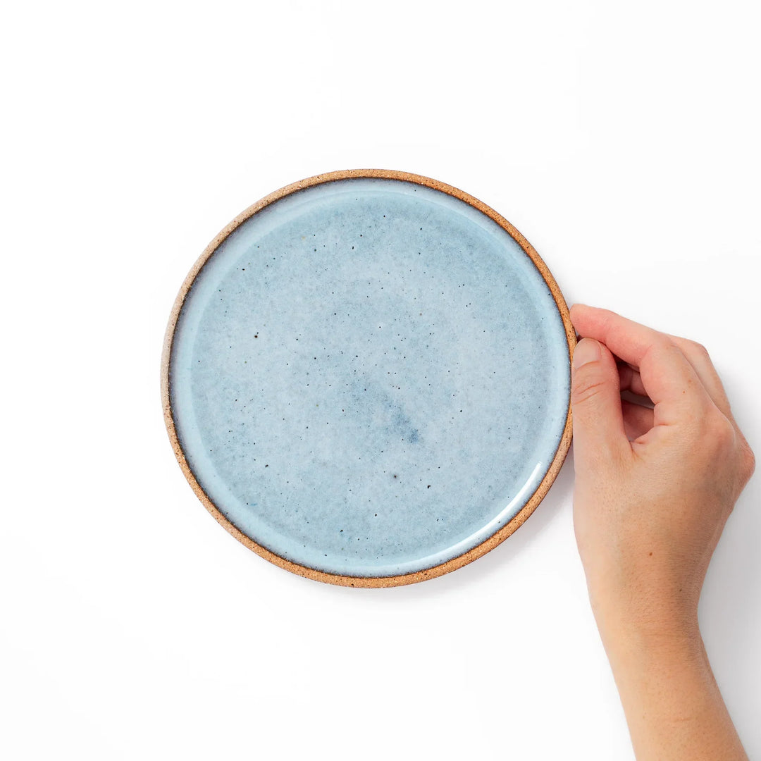 Terracotta blue ceramic dessert plate with rustic brown rim, handcrafted in Japan for serving cake, pastry, or appetizers.