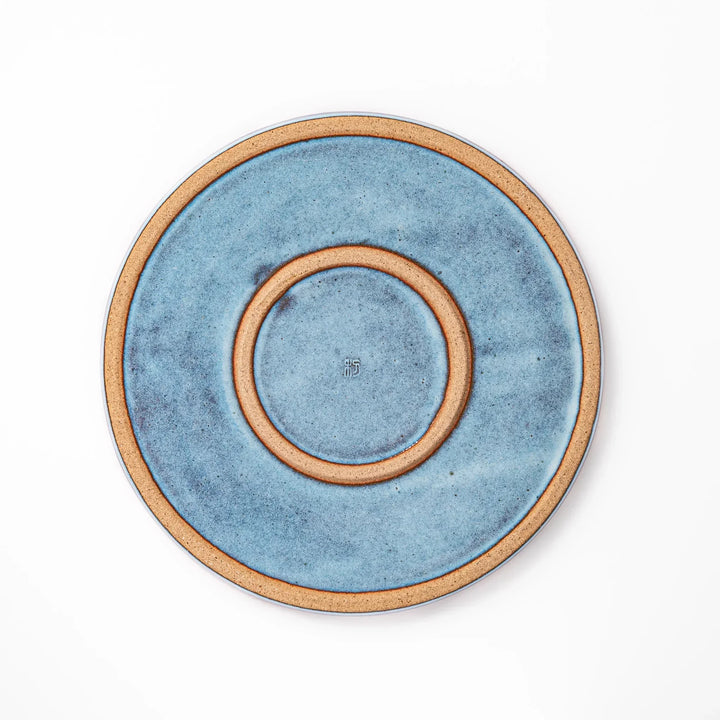 Terracotta blue ceramic dinner plate with rustic brown rim, handcrafted in Japan for daily meals or pasta dishes.