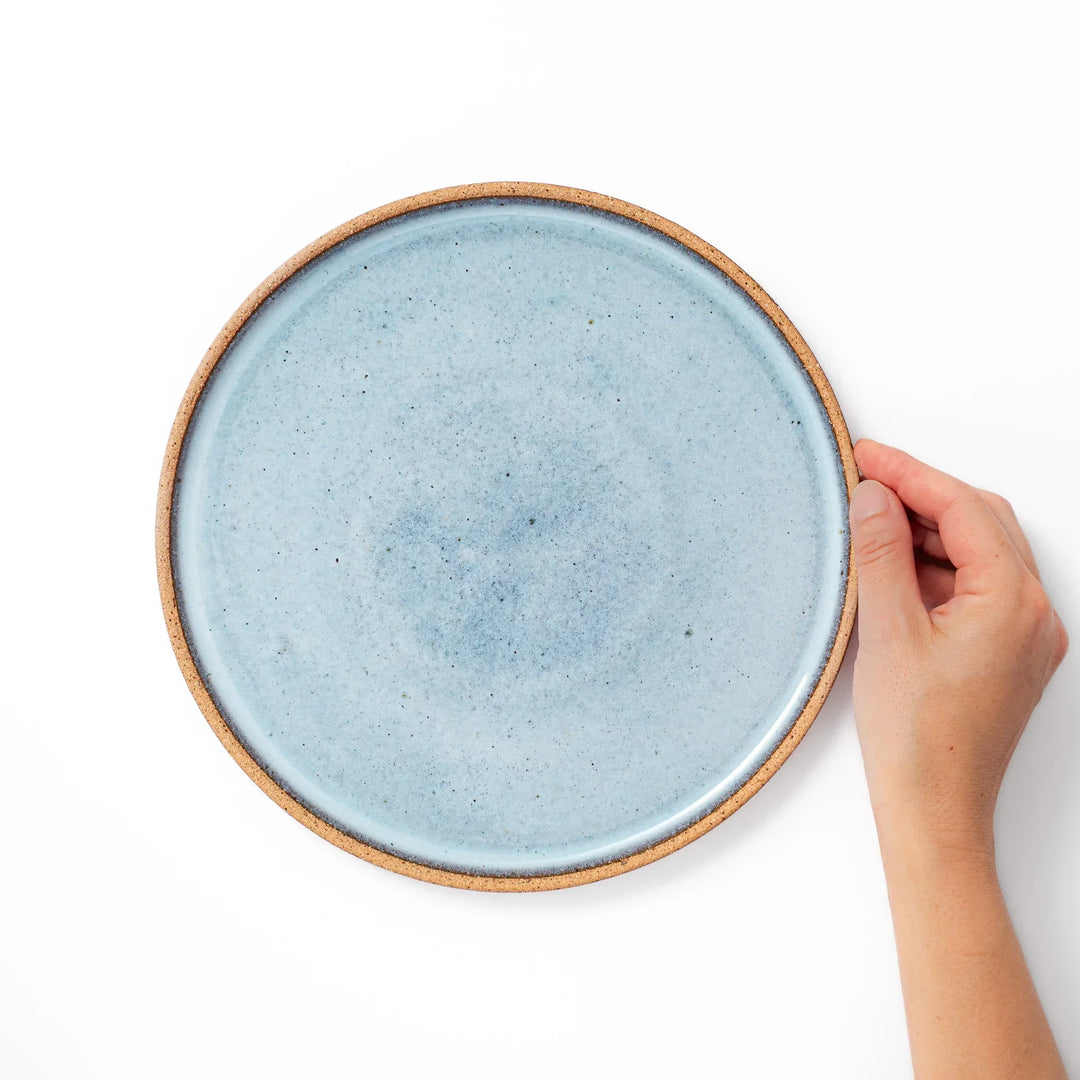 Terracotta blue ceramic dinner plate with rustic brown rim, handcrafted in Japan for daily meals or pasta dishes.