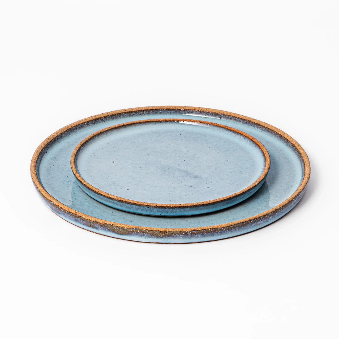 Terracotta blue ceramic dinner plate with rustic brown rim, handcrafted in Japan for daily meals or pasta dishes.