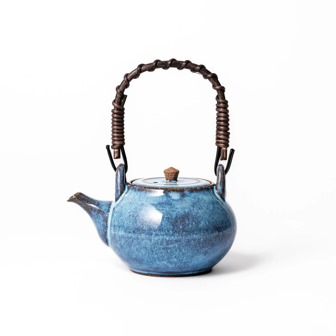 Terracotta blue ceramic teapot with rustic brown rim and metal handle, handcrafted in Japan for daily tea service.