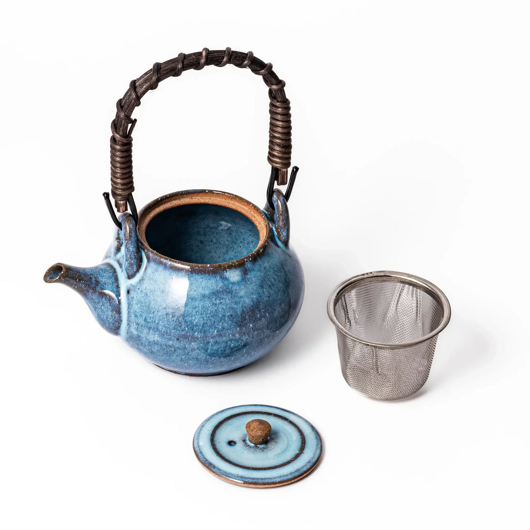 Terracotta blue ceramic teapot with rustic brown rim and metal handle, handcrafted in Japan for daily tea service.