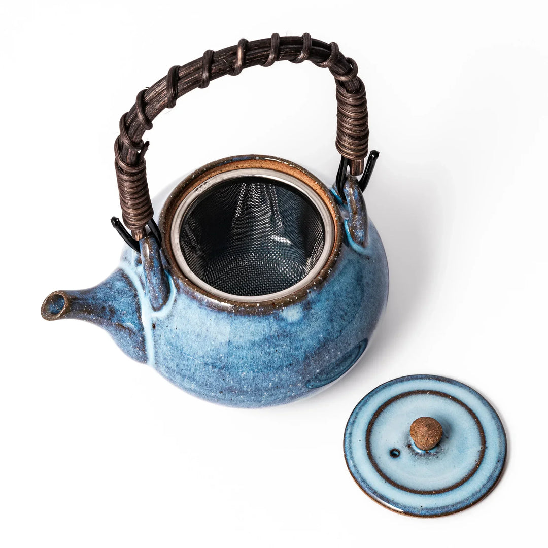 Terracotta blue ceramic teapot with rustic brown rim and metal handle, handcrafted in Japan for daily tea service.