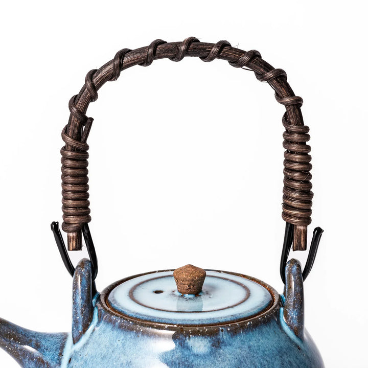 Terracotta blue ceramic teapot with rustic brown rim and metal handle, handcrafted in Japan for daily tea service.