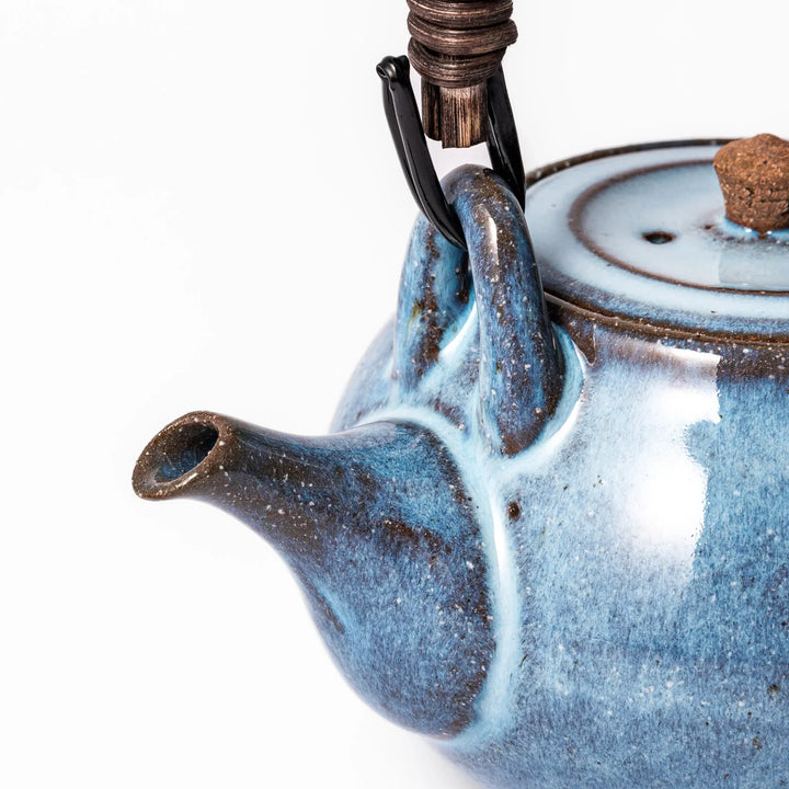 Terracotta blue ceramic teapot with rustic brown rim and metal handle, handcrafted in Japan for daily tea service.