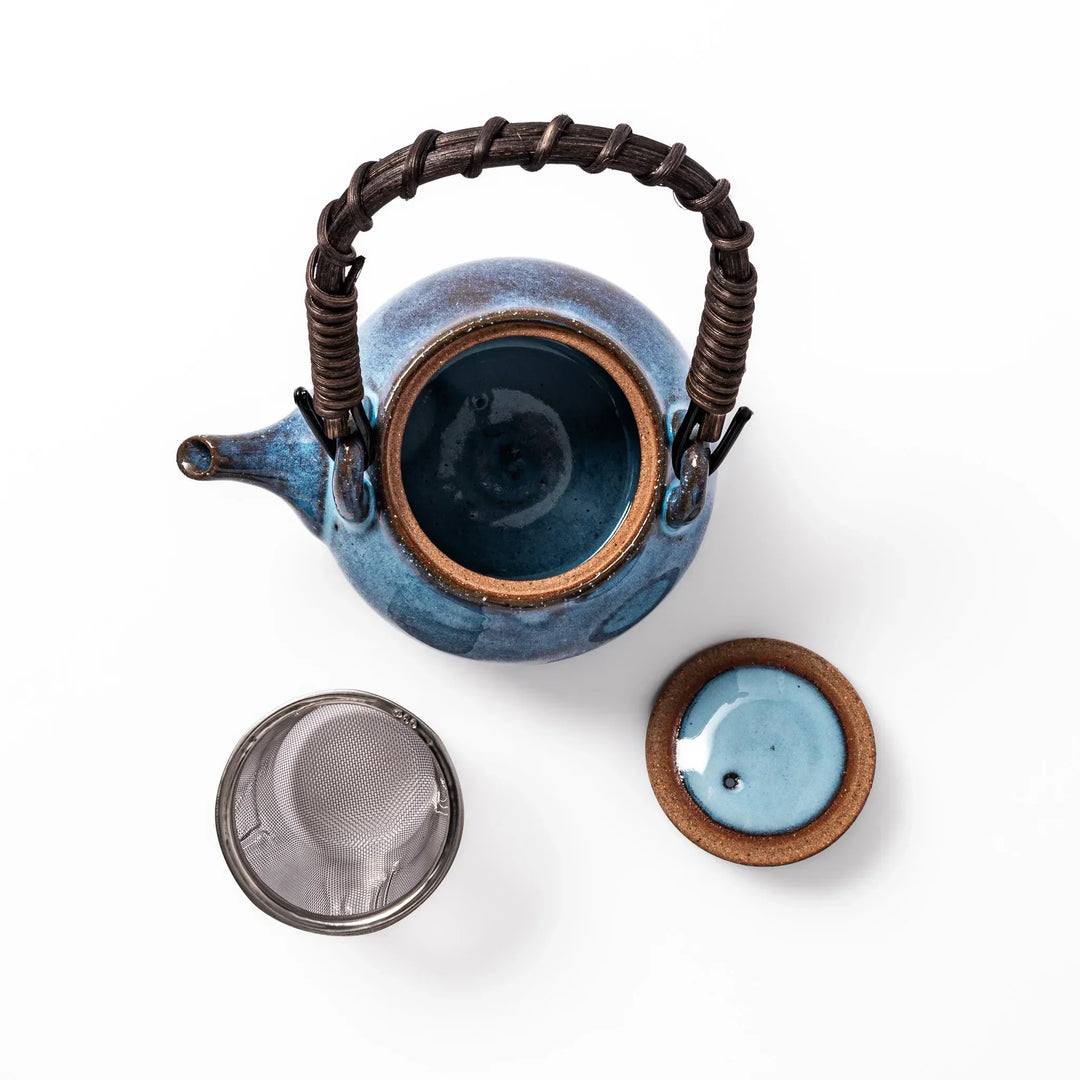 Terracotta blue ceramic teapot with rustic brown rim and metal handle, handcrafted in Japan for daily tea service.
