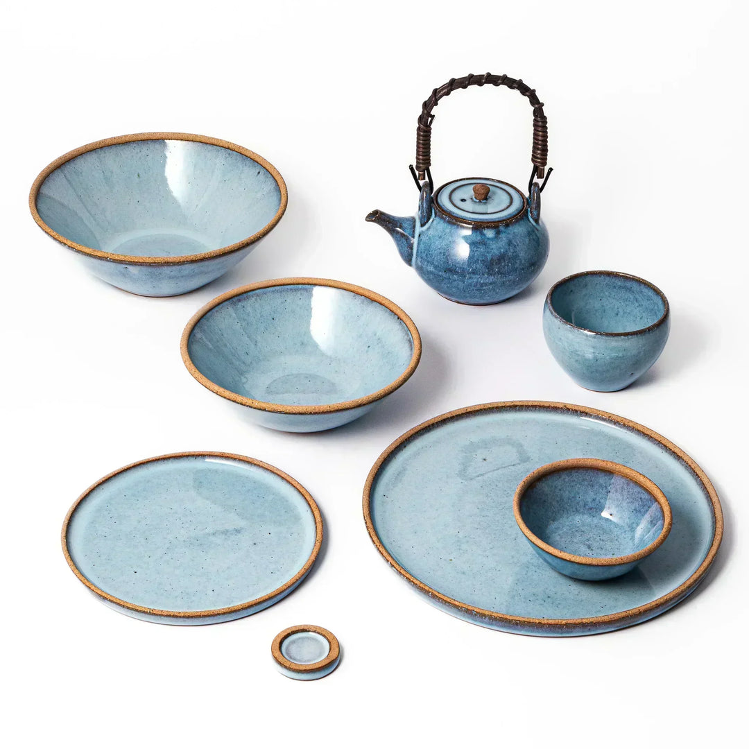 Terracotta blue ceramic dinner plate with rustic brown rim, handcrafted in Japan for daily meals or pasta dishes.