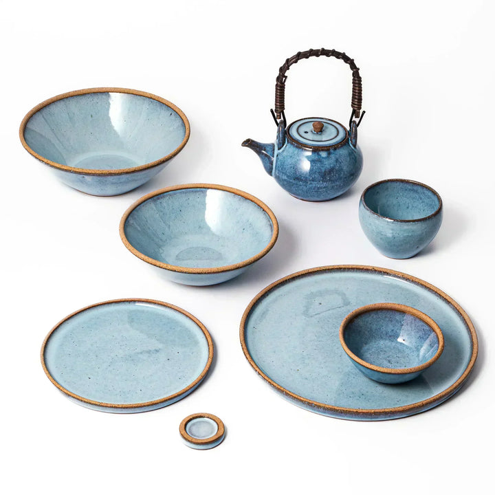 Terracotta blue ceramic dinner plate with rustic brown rim, handcrafted in Japan for daily meals or pasta dishes.