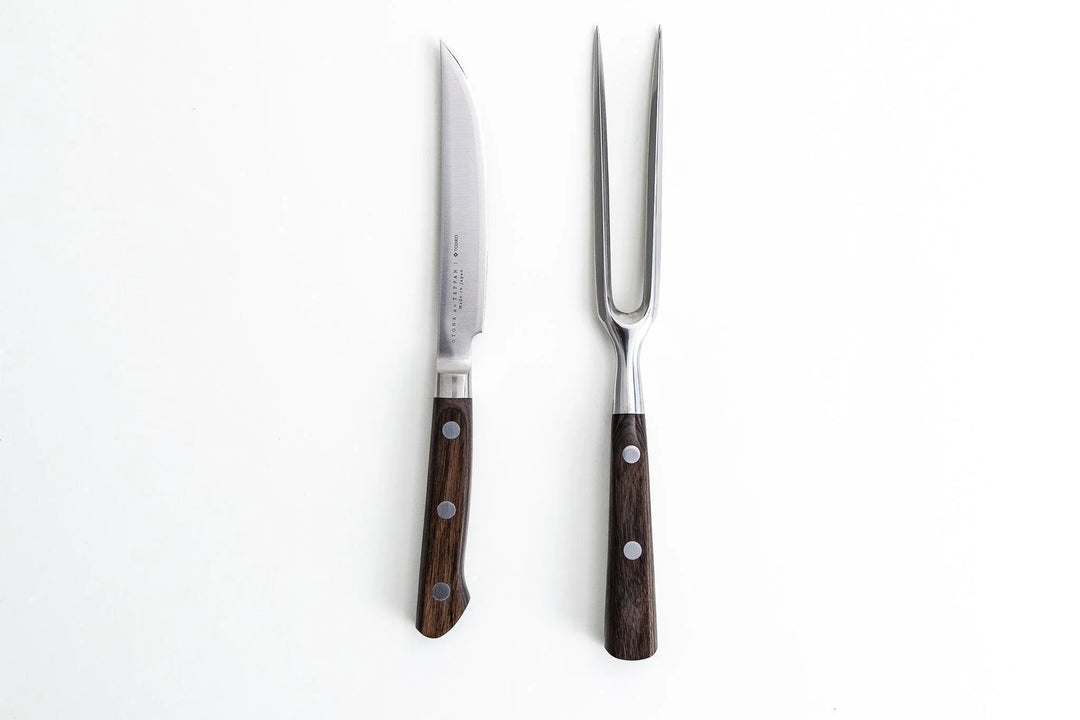Japanese carving knife and meat fork with dark wood handles on a white background