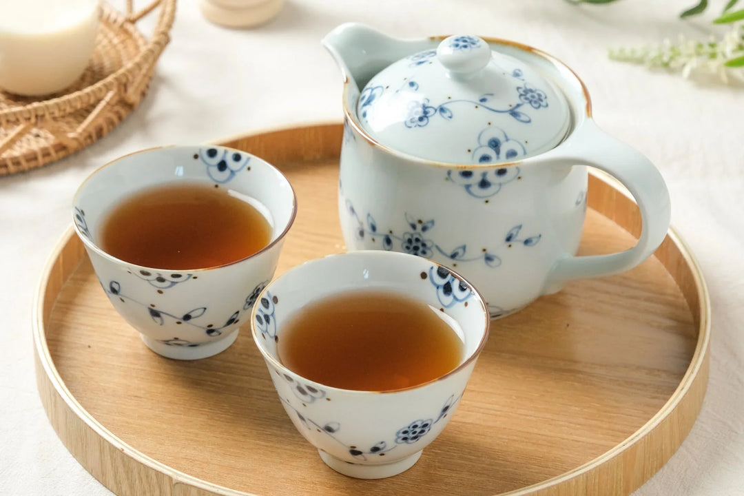Japanese blue and white porcelain teapot and cups on a wooden tray for a peaceful tea setting