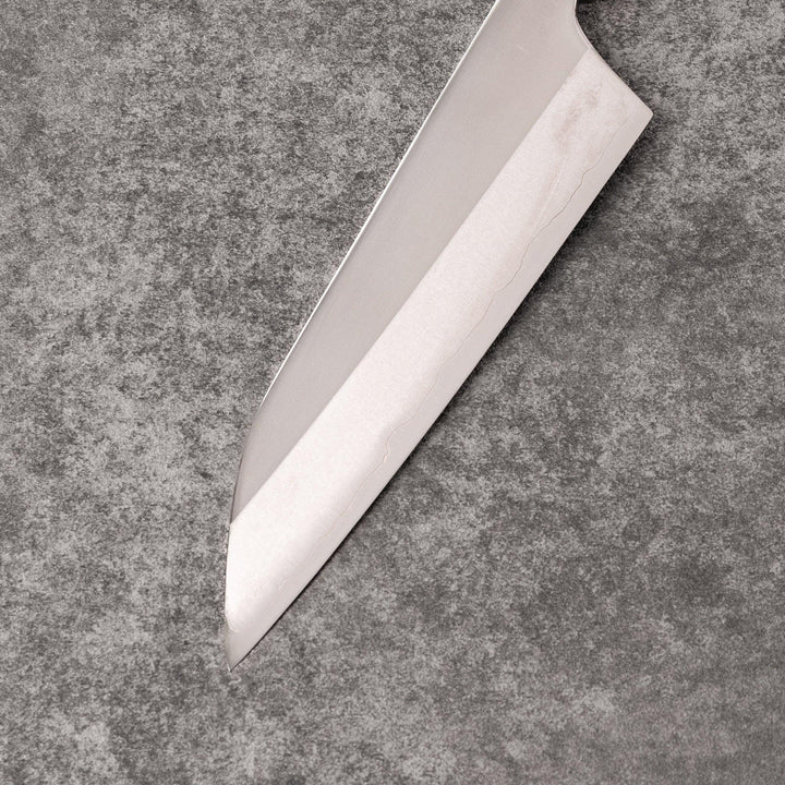 Petty knife with polished stainless steel blade and walnut wood handle for precise vegetable slicing and peeling.
