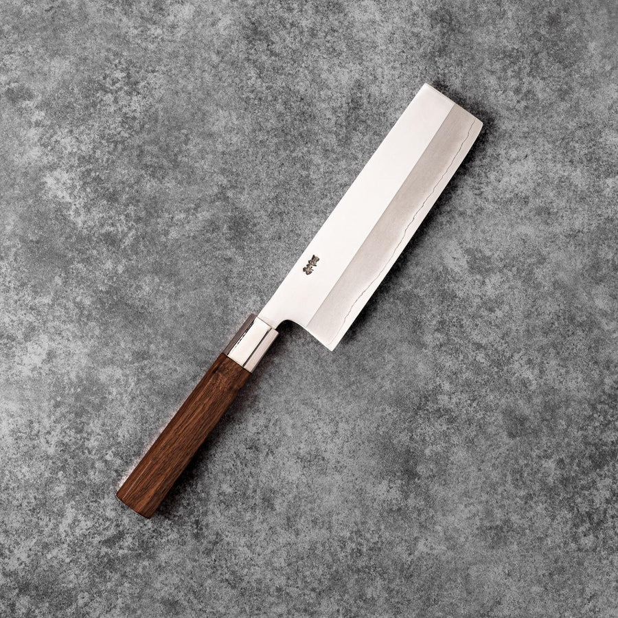 Tosa ginsan nakiri vegetable knife authentic japanese chef knife with wooden handle on textured stone background cutlery