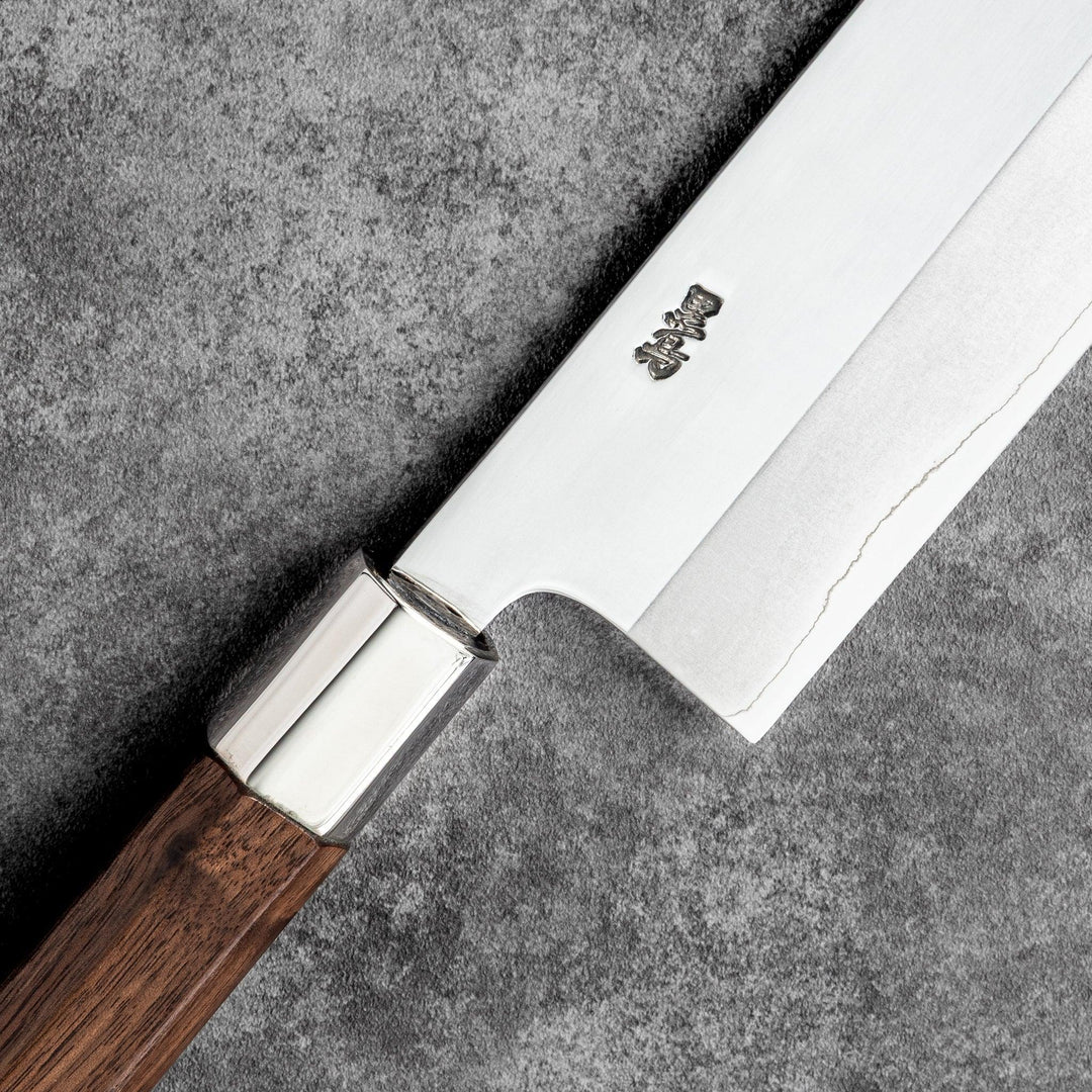 Tosa ginsan nakiri vegetable knife authentic japanese chef knife with wooden handle on textured stone background cutlery