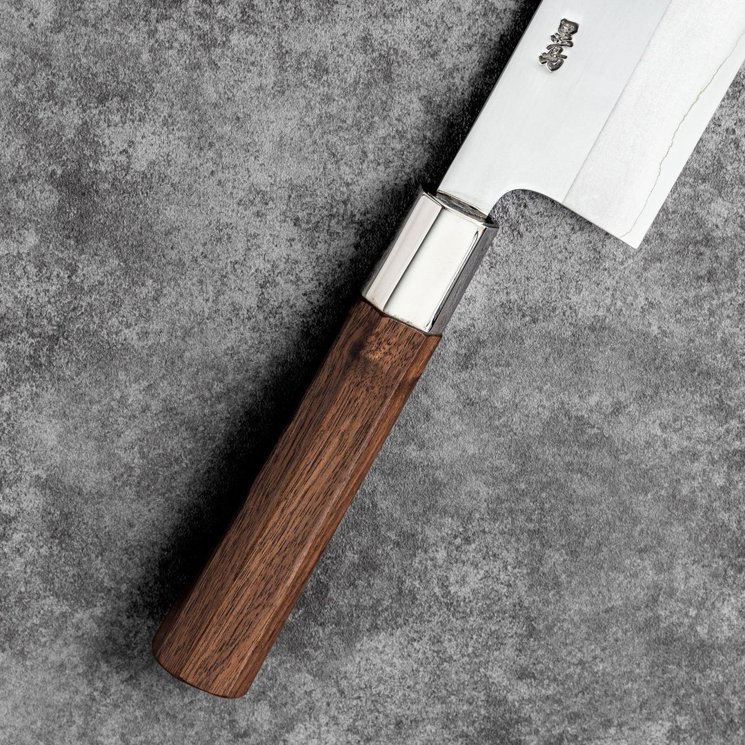 Tosa ginsan nakiri vegetable knife authentic japanese chef knife with wooden handle on textured stone background cutlery