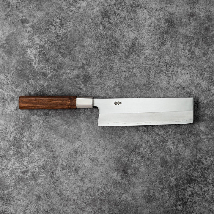 Tosa ginsan nakiri vegetable knife authentic japanese chef knife with wooden handle on textured stone background cutlery