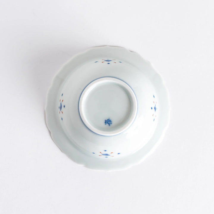 A porcelain bowl with colorful geometric patterns and floral motifs on the interior.