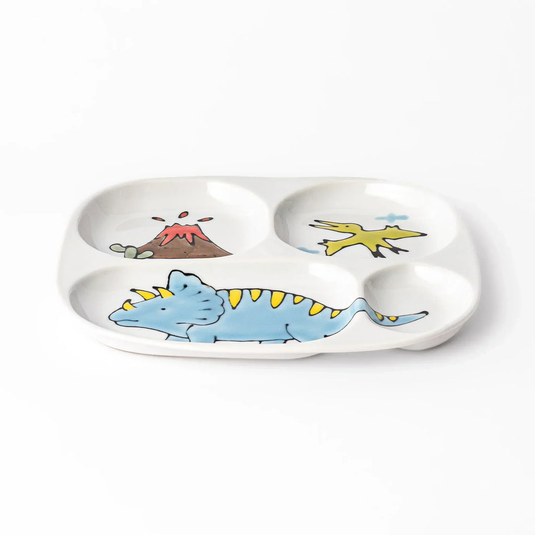 White ceramic kids divided plate with blue triceratops, yellow pterodactyl, red erupting volcano and blue cloud accents