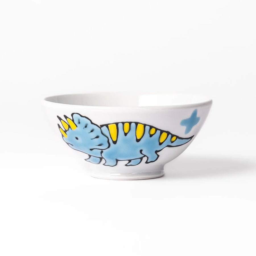 White ceramic kids rice bowl featuring blue triceratops dinosaur with yellow accents and blue cloud motifs