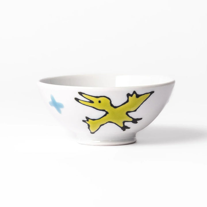White ceramic kids rice bowl featuring blue triceratops dinosaur with yellow accents and blue cloud motifs
