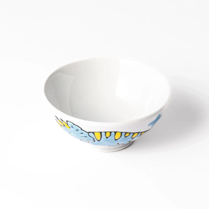 White ceramic kids rice bowl featuring blue triceratops dinosaur with yellow accents and blue cloud motifs
