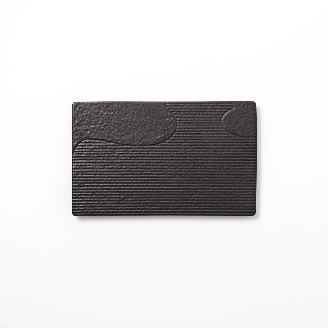 Black Japanese ceramic dinner plate with ridged woodgrain texture and matte gloss finish for modern dining.