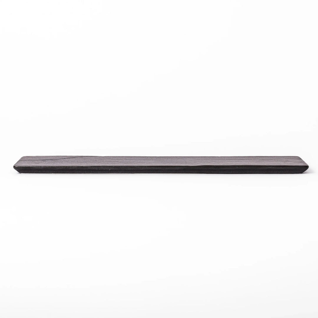 Rectangular black Japanese ceramic serving plate with subtle ridged woodgrain texture for modern dining.