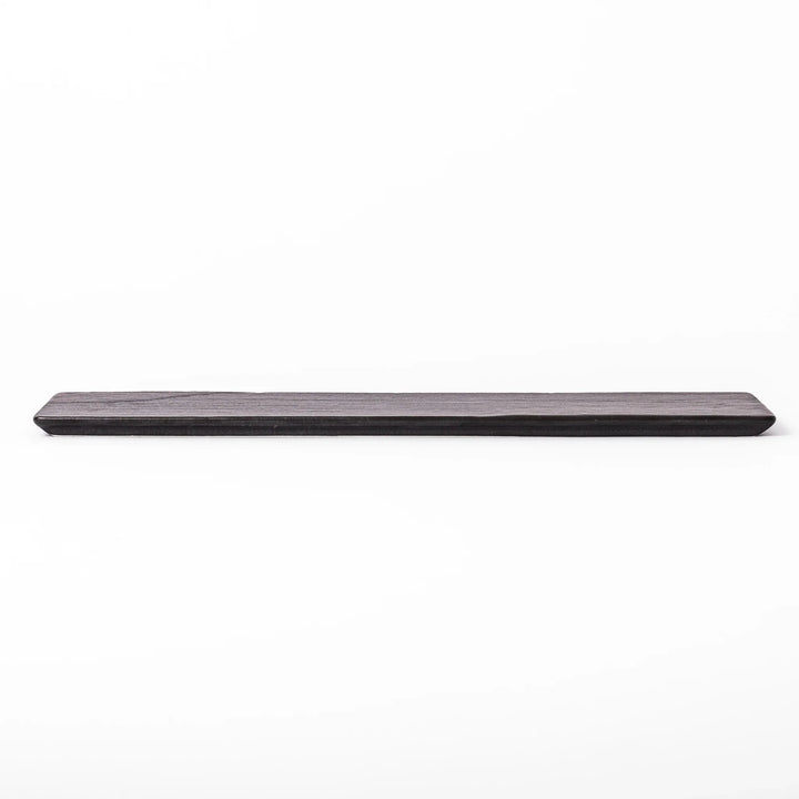 Rectangular black Japanese ceramic serving plate with subtle ridged woodgrain texture for modern dining.