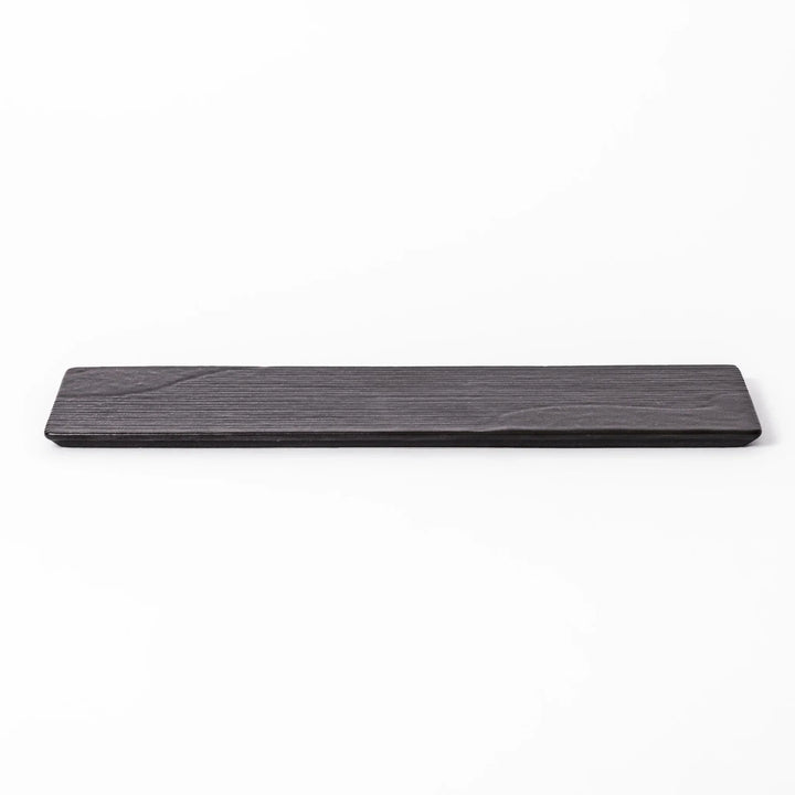 Rectangular black Japanese ceramic serving plate with subtle ridged woodgrain texture for modern dining.