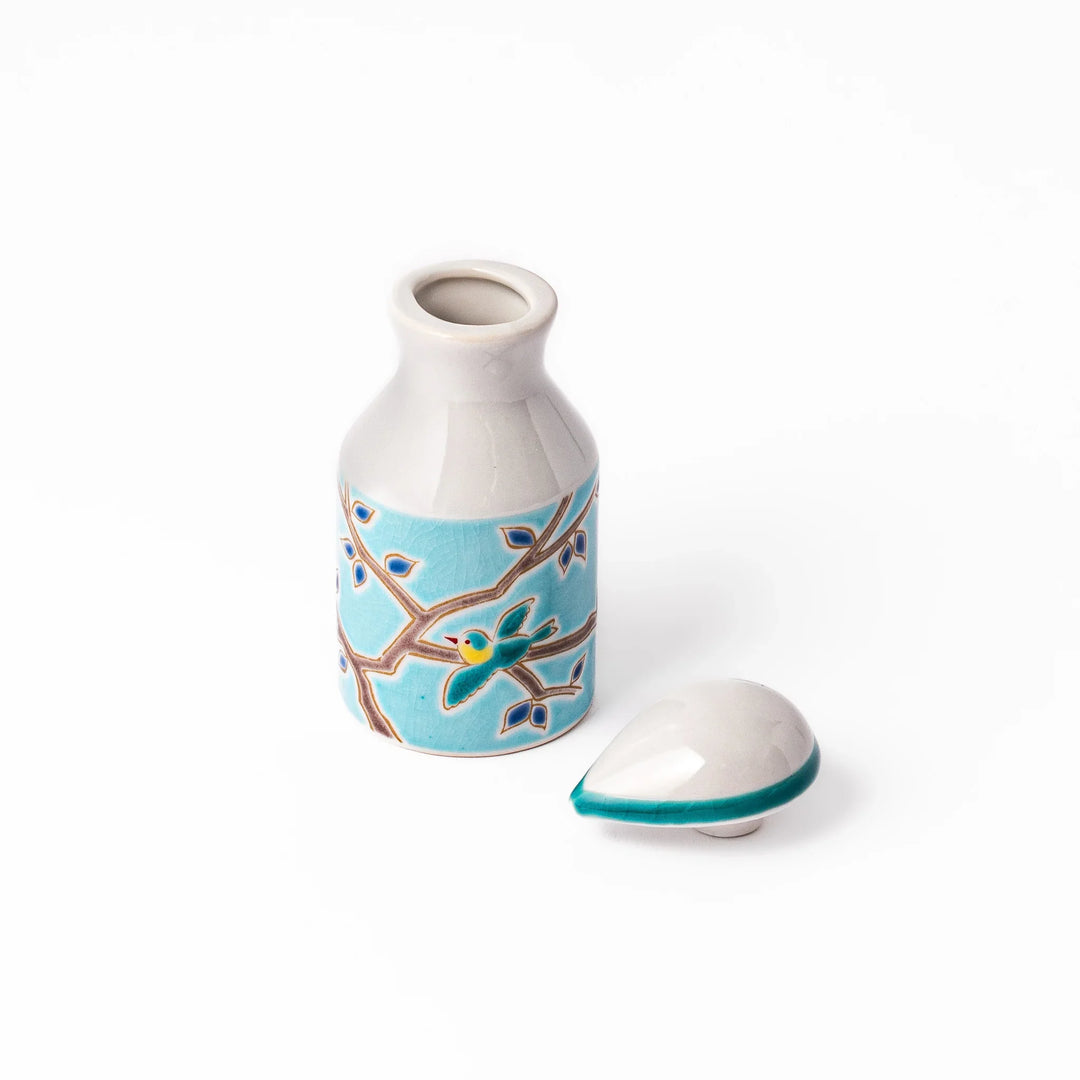 Japanese ceramic soy sauce dispenser with a turquoise lid and bird and branch motif, beautifully handcrafted in Arita Japan.