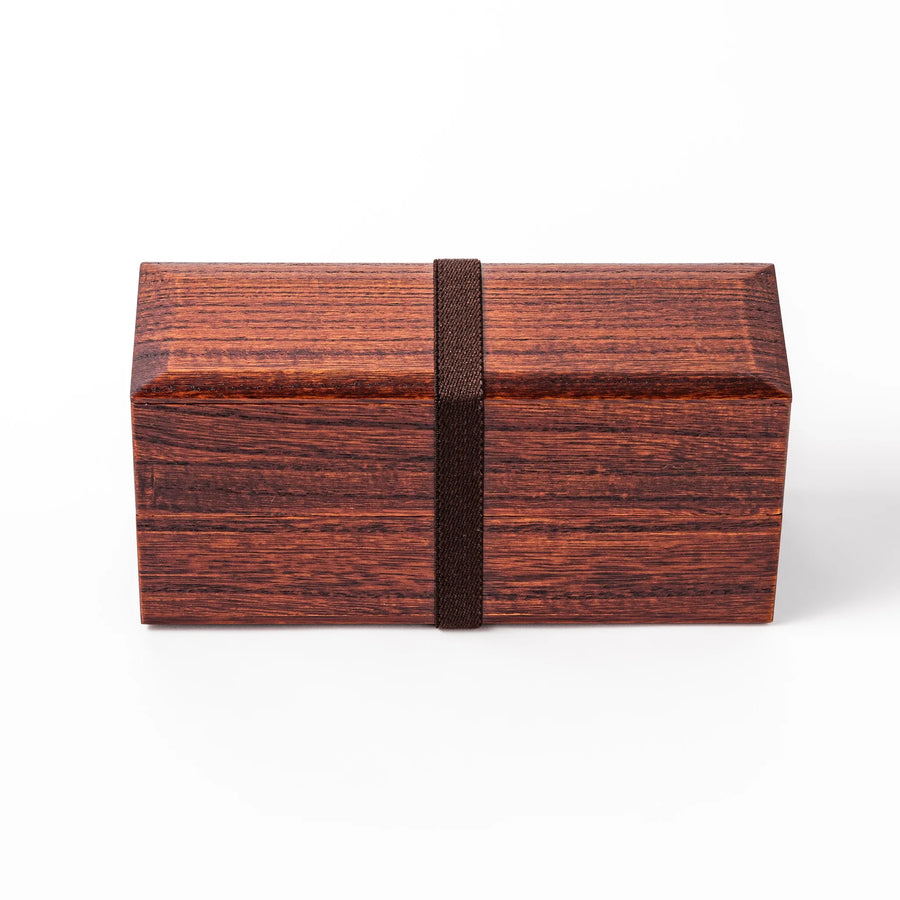 Dark brown Japanese two tier bento box made of paulownia wood with black band for elegant lunch style.