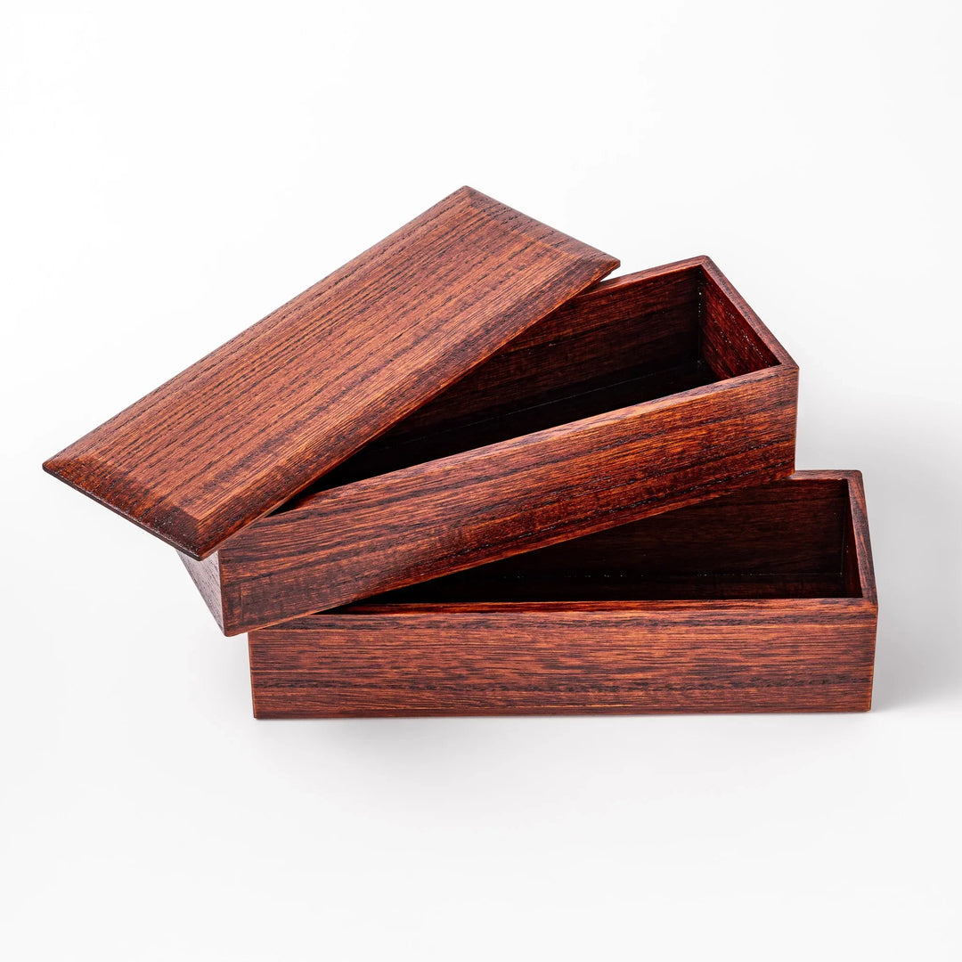 Rectangular Japanese two tier bento box made of dark brown paulownia wood with sleek minimalist design.