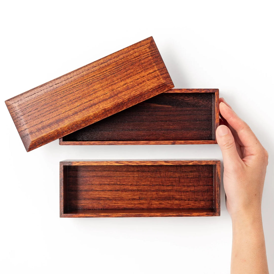 Rectangular Japanese two tier bento box made of dark brown paulownia wood with sleek minimalist design.