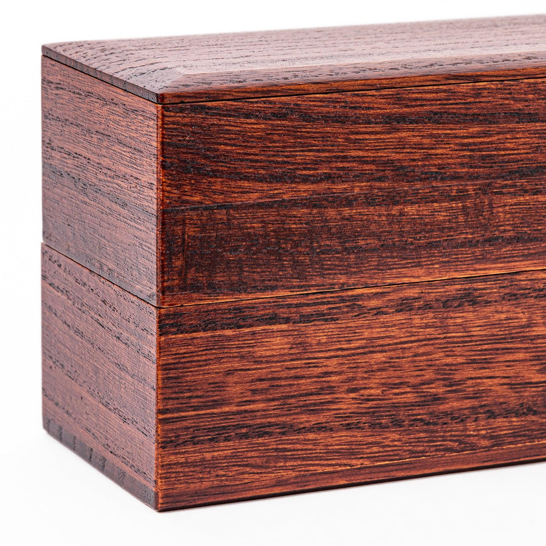 Rectangular Japanese two tier bento box made of dark brown paulownia wood with sleek minimalist design.