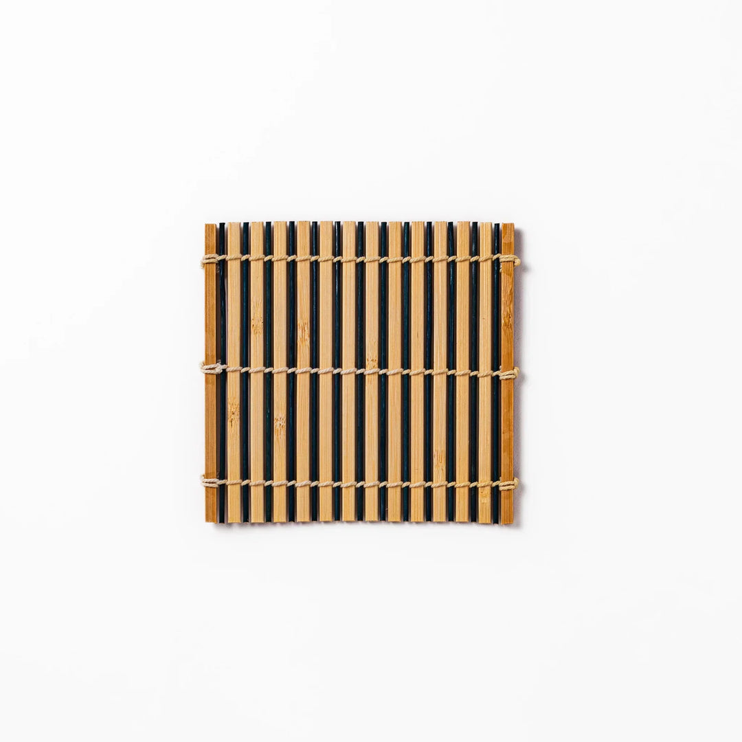 Two tone bamboo coaster with dark and natural slats hand tied with twine for stylish Japanese settings.