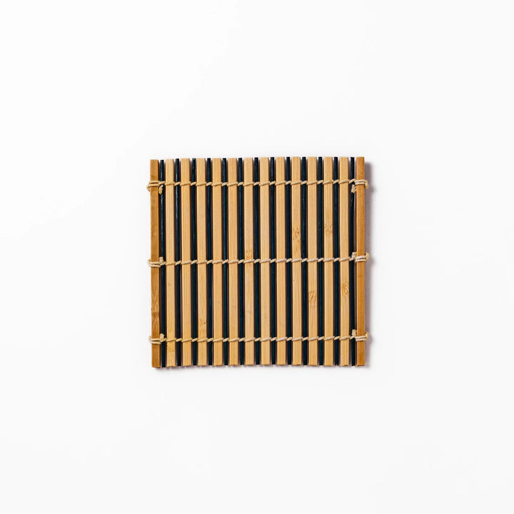 Two tone bamboo coaster with dark and natural slats hand tied with twine for stylish Japanese settings.