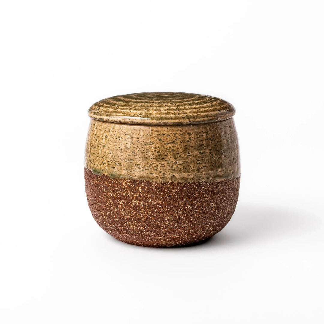 Two tone Japanese ceramic rice storage bowl with lid glazed top and textured brown base for rustic charm.