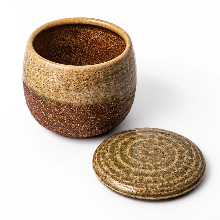 Two tone Japanese ceramic rice storage bowl with lid glazed top and textured brown base for rustic charm.