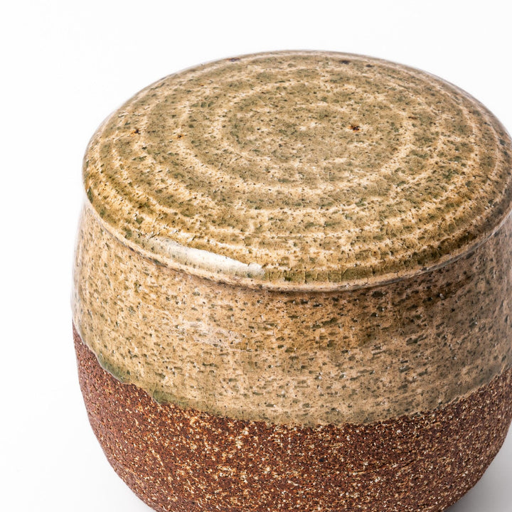 Two tone Japanese ceramic rice storage bowl with lid glazed top and textured brown base for rustic charm.