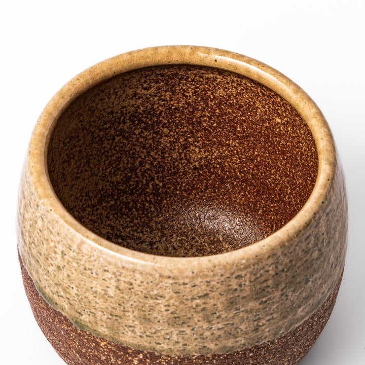 Two tone Japanese ceramic rice storage bowl with lid glazed top and textured brown base for rustic charm.