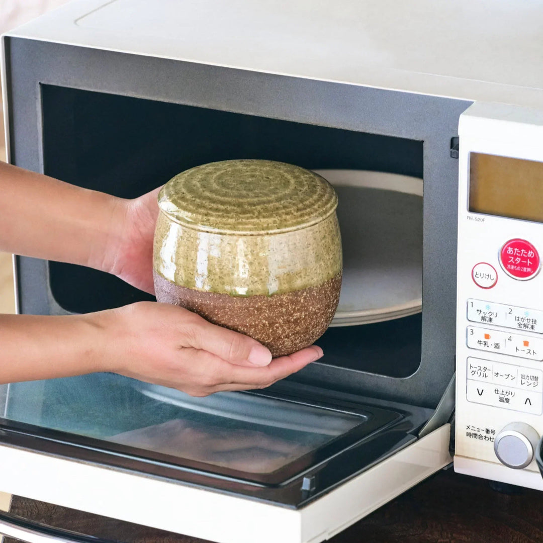 Two tone Japanese ceramic rice storage bowl with lid glazed top and textured brown base for rustic charm.