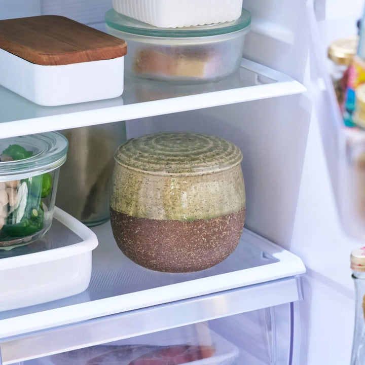 Two tone Japanese ceramic rice storage bowl with lid glazed top and textured brown base for rustic charm.