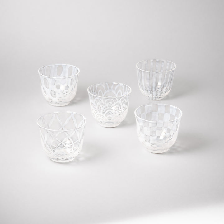 Set of vintage Japanese glass tea cups top view with assorted etched patterns lattice polka dot stripe and wave design