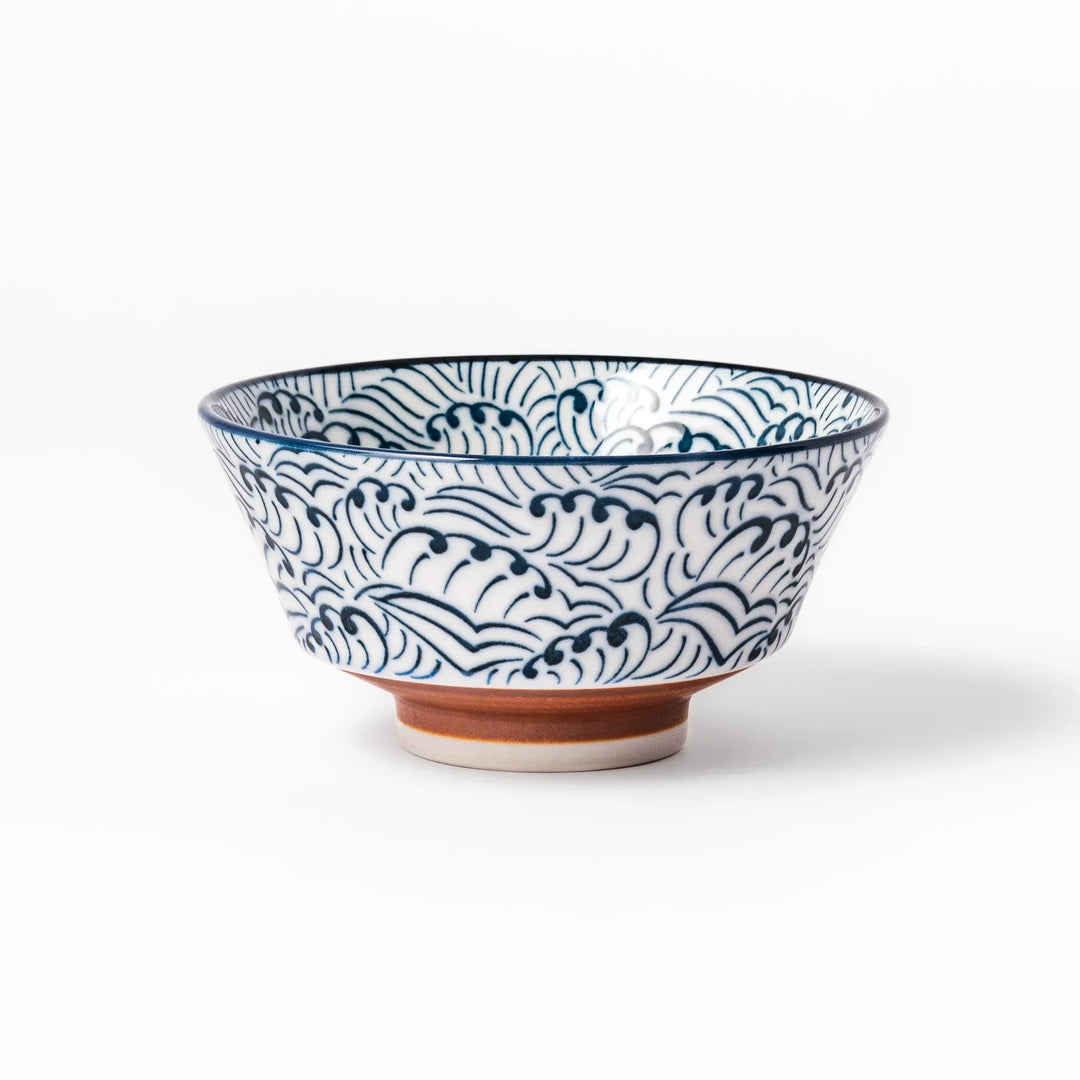 White porcelain rice bowl with navy blue wave ripple pattern and unglazed brown base, photographed on a white background.