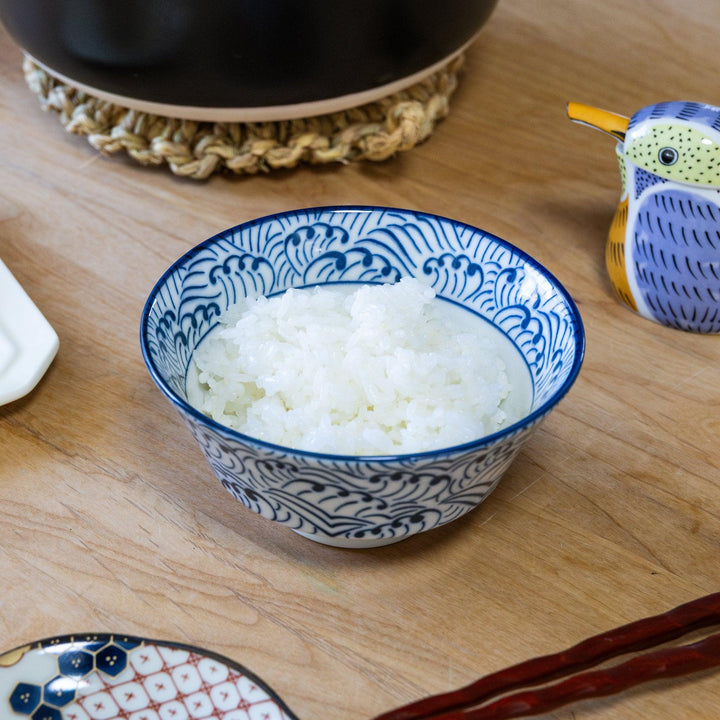 Steamed Japanese rice served in blue and white patterned ceramic rice bowl on wooden table