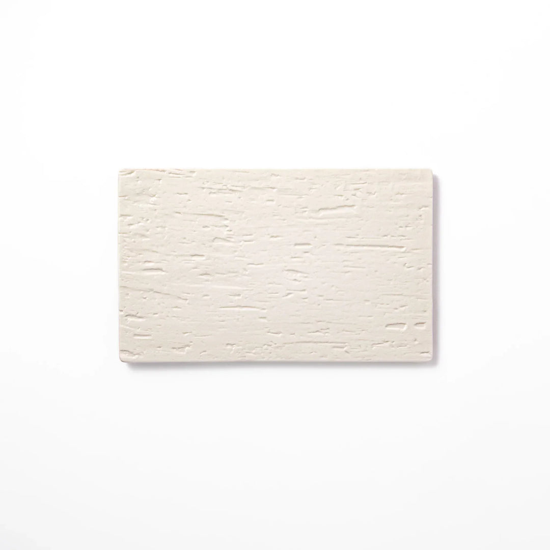 White Japanese ceramic dinner plate with subtle woodgrain texture for elegant minimalist table settings.