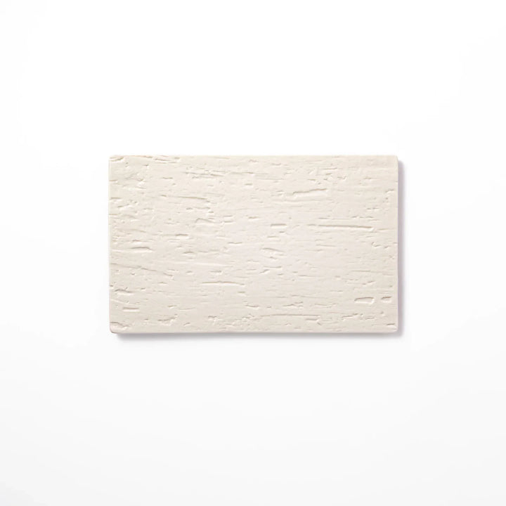 White Japanese ceramic dinner plate with subtle woodgrain texture for elegant minimalist table settings.