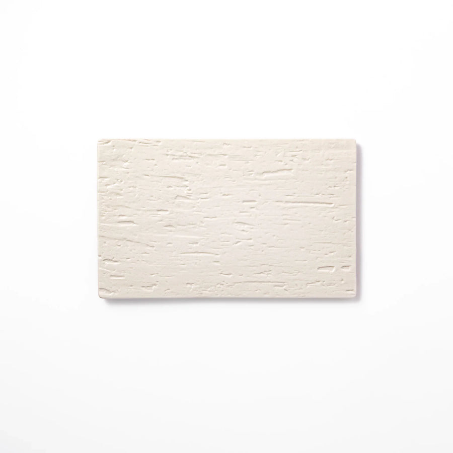 White Japanese ceramic dinner plate with subtle woodgrain texture for elegant minimalist table settings.