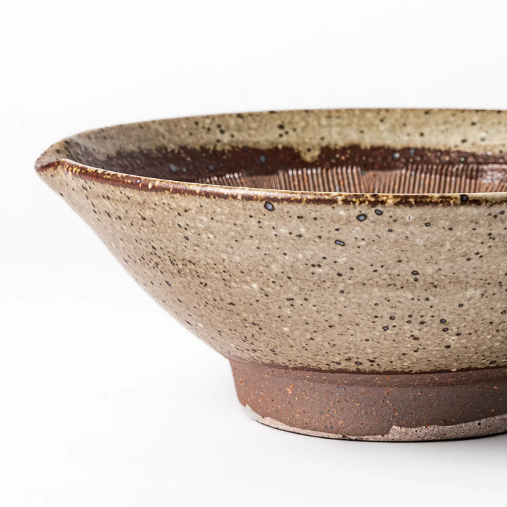 Speckled white Karatsu-style mortar with a deep brown interior and textured ridges, ideal for traditional sesame grinding.