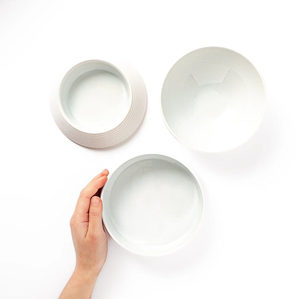White porcelain moon shaped jubako set shown open with lid and inner bowls