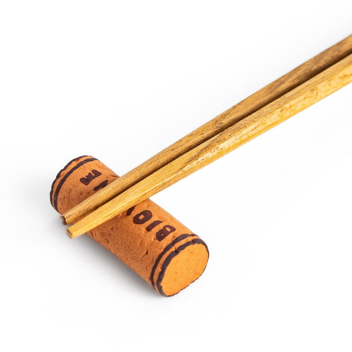 Fun chopstick rest shaped like a wine cork, featuring the word "BIOWINE" printed in bold on the side for a playful touch.